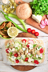 Shawarmas french fries and vegetables on white wooden table