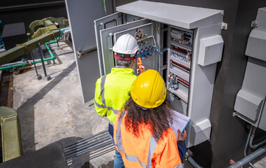 The engineer checking and inspecting at MDB panel .he working with electric switchboard to check...