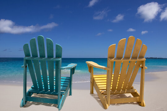 Two beach chairs on white sand Caribbean coast