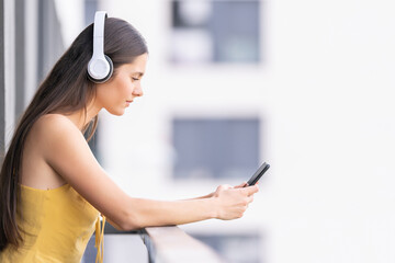 Happy woman listening to music with headphones