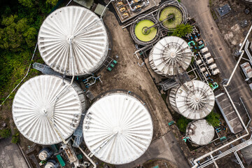 Aerial view directly above storage tanks and silos with connecting pipework