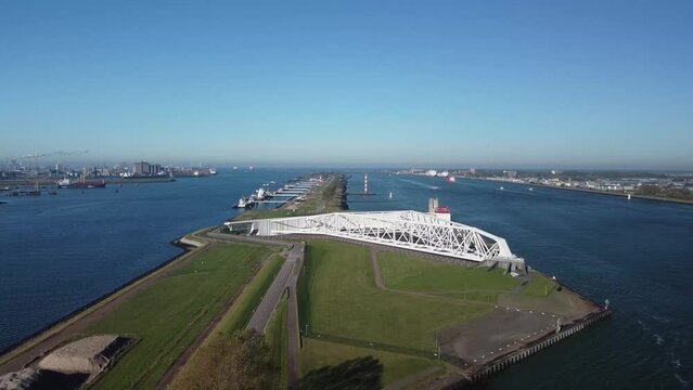 Aerial bird view of Maeslantkering a storm surge barrier on dividing line between Nieuwe Waterweg waterway located near Rotterdam one of largest harbors in world Delta Works Delta Werken Deltaworks 4k