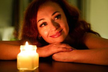 Fototapeta na wymiar Happy woman enjoying spa. Smiling girl with aroma candle. Relaxation massage