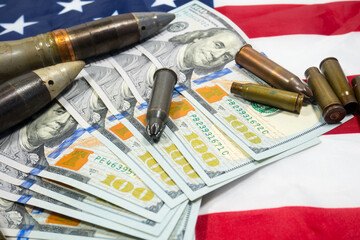 American flag with dollars money, bullets, shells, cartridges and projectiles on it. Lend-Lease concept.  Army concept. Sales of weapons and ammunition..Military industry, war, global arms trade.