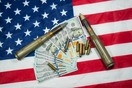 American Flag With Dollars Money, Bullets, Shells, Cartridges And Projectiles On It. Lend-Lease Concept.  Army Concept. Sales Of Weapons And Ammunition..Military Industry, War, Global Arms Trade.