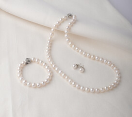 Set of pearl jewelry display on white cloth