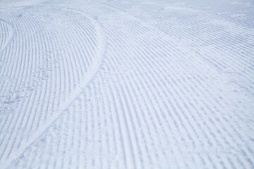Striped texture of a snowy ski slope