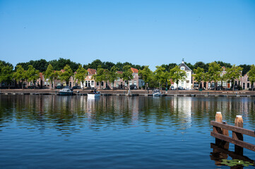 Fototapeta na wymiar Blokzijl, Overijssel, The Netherlands - Landscape view over the harbor and lake on a hot summer day