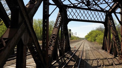 Railroad train bridge iron works with track extending to horizon