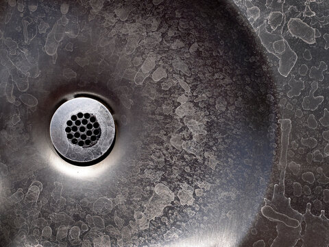 Old Metal Drain with Water Stains on Steel Sink