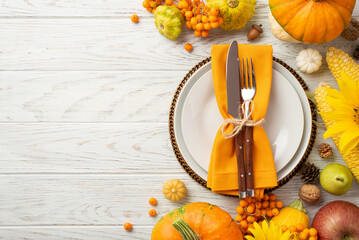 Thanksgiving day concept. Top view photo of plate knife fork napkin raw vegetables pumpkins maize...