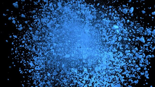 Super Slow Motion Shot of Rotating Blue Powder Expolosion Isolated on Black Background at 1000fps.