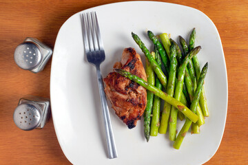 baked chicken thigh   with sauteed asparagus