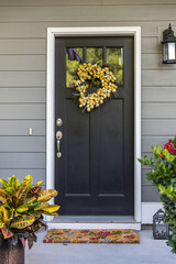 A black front door to a townhouse, apartment or condominium