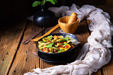 Pasta salad with green asparagus, olives and parma ham