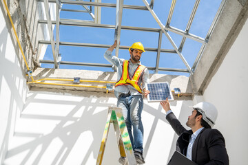 Engineers with Businessmen discussing and checking solar cell for residential under construction.