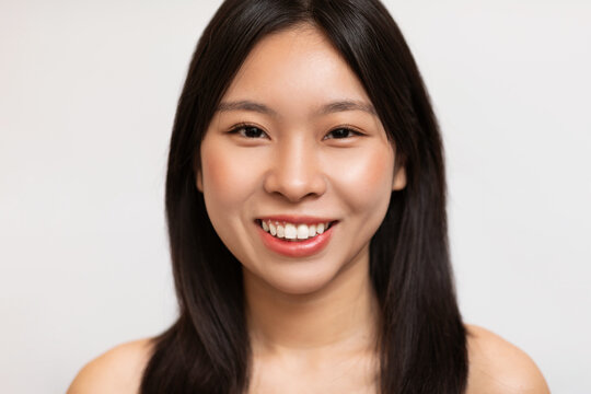 Natural beauty. Portrait of happy korean lady with natural makeup and healthy smooth skin posing on white background