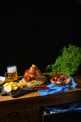 rustic pork knuckle with sauerkraut, sweet mustard and fried potatoes