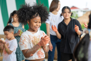 African American little girls and friends have fun hands painted in colorful paint.education concept