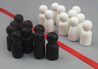 Groups of white and black people figures separated by red line on gray background. Racial...