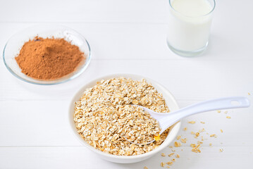 plate of oatmeal and cocoa carob and a glass of milk. healthy food. diet.