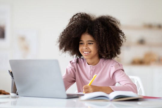 Happy Black Girl Sitting In Front Of Computer, Doing Homework