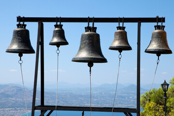 Bells  at Saint Patapios monastery in Loutraki, Peloponnese, Greece, against blue sky. Sunny day