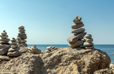 Stack of zen stones by the sea. Harmony, balance. Towers of balanced stones on the beach.