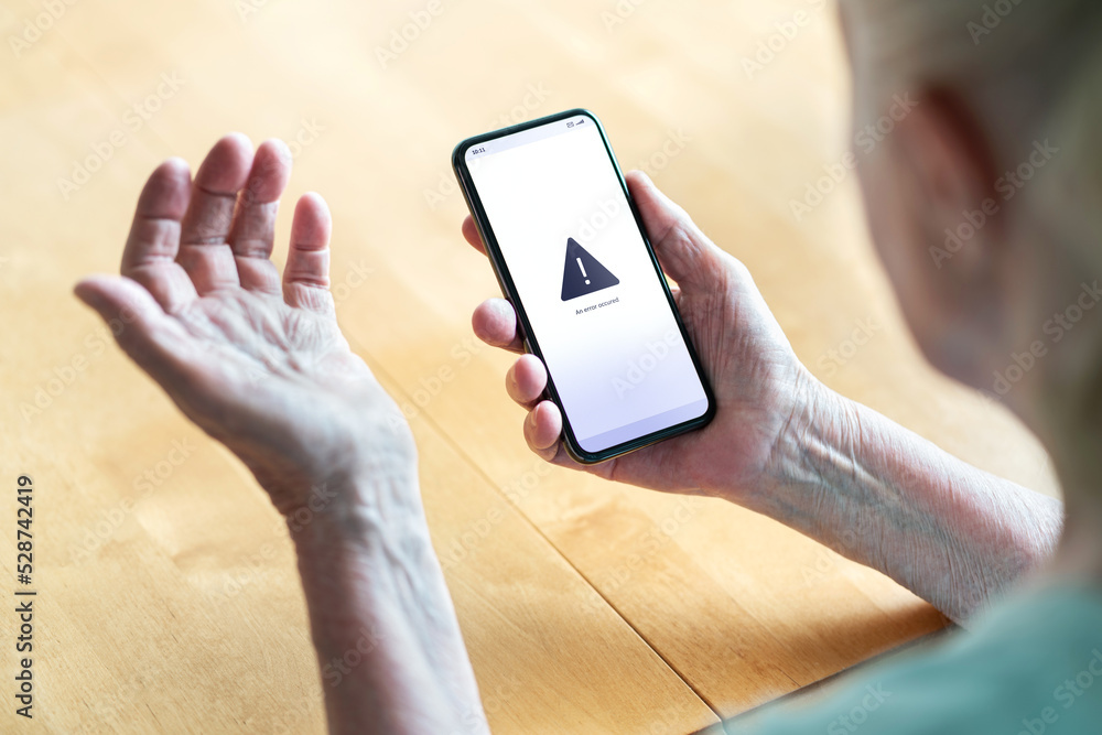 Wall mural senior having problem with phone and technology. old woman with error message in smartphone screen. 