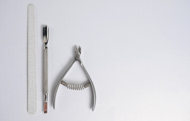 Nippers, pusher and nail file for manicure and pedicure on a white background.