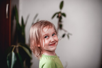 Portrait of a cute teen girl indoors, smile on the face of a pretty girl looking at the camera.