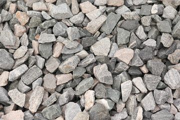 Background of gray stones. Stones are large structures, only a couple of stones fit in the palm.