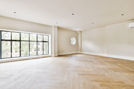Plastic window and radiator on white wall in empty light room at home