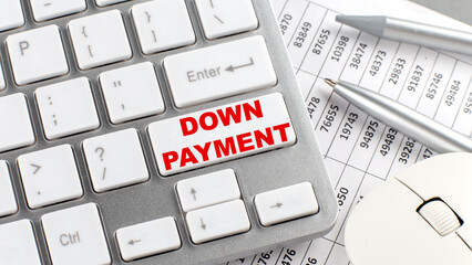DOWN PAYMENT text on a keyboard wirh chart and pencil