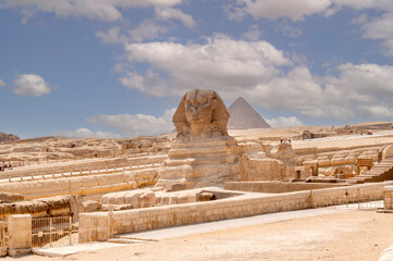 Sphinx of Giza in the desert of Cairo with the pyramid of Menkaure in the background