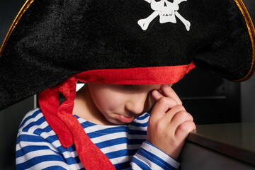portrait of offended boy in pirate costume crying at party