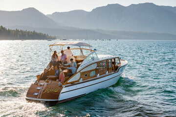 A group of friends have a toast on a yacht on a Summer afternoon.