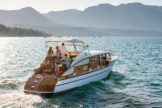 A group of friends have a toast on a yacht on a Summer afternoon.