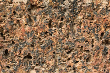 Laterite brick wall background and texture. Natural Laterite rock for outdoor and tropical garden or garden wall decoration. 