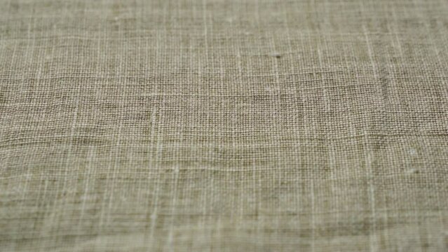 Closeup natural linen texture background. Abstract thread pattern on a linen fabric