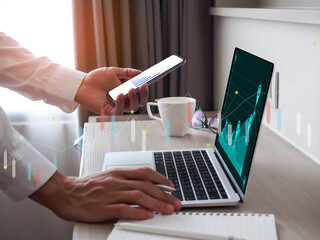 Data analyst using laptop and smartphone to analysis of a big data, data analysis and financial network strategy.