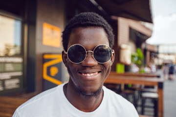 Portrait of an african american man in round sunglasses.