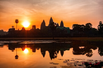 Ancient Angkor Wat temple in Siem Reap, Cambodia silhouette at sunrise with reflection.
