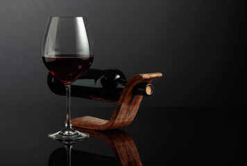 Red wine on a black reflective background.