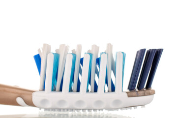 One plastic toothbrush, close-up, isolated on a white background.