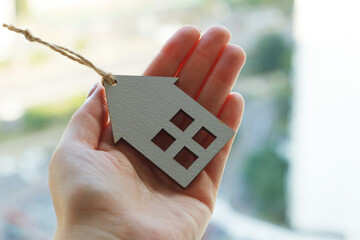 hands holding wooden house, family home, homeless shelter and real estate, housing and mortgage...