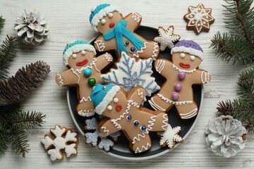 Delicious Christmas cookies, pine cones and fir branches on white wooden table, flat lay