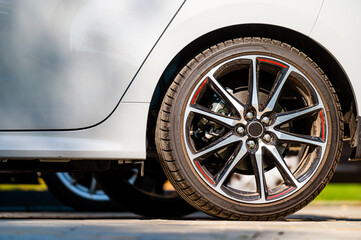 Fototapeta na wymiar sports car wheels, low profile tires on aluminum rims, closeup