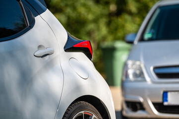closeup of fragments of cars parked in the yard of a residential house