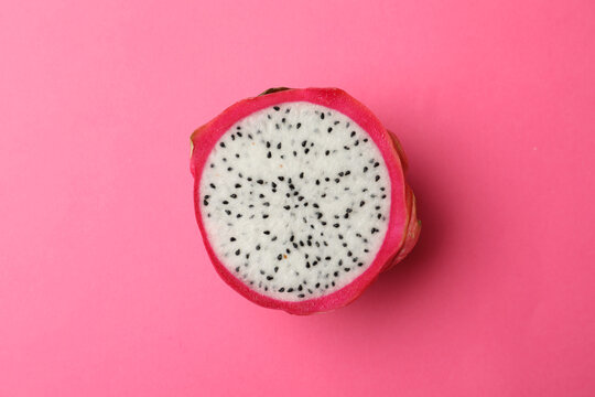 Half of delicious ripe dragon fruit (pitahaya) on pink background, top view